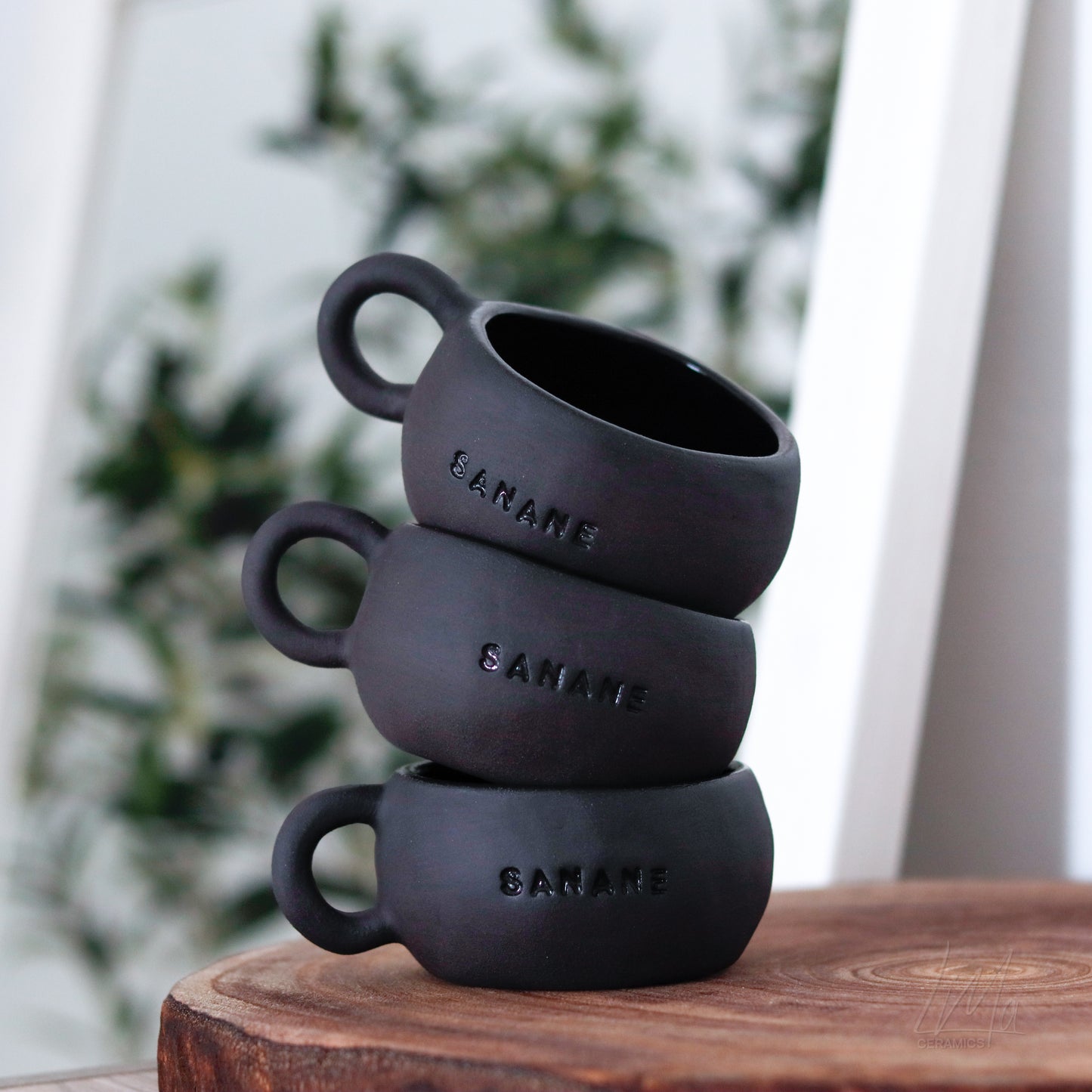 Motto Tasse schwarz „SANANE“